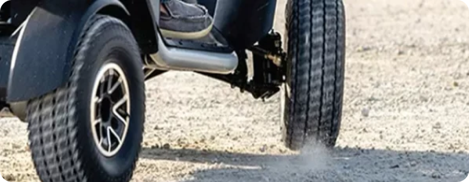 Image shows terrain style wheels on a mobility scooter