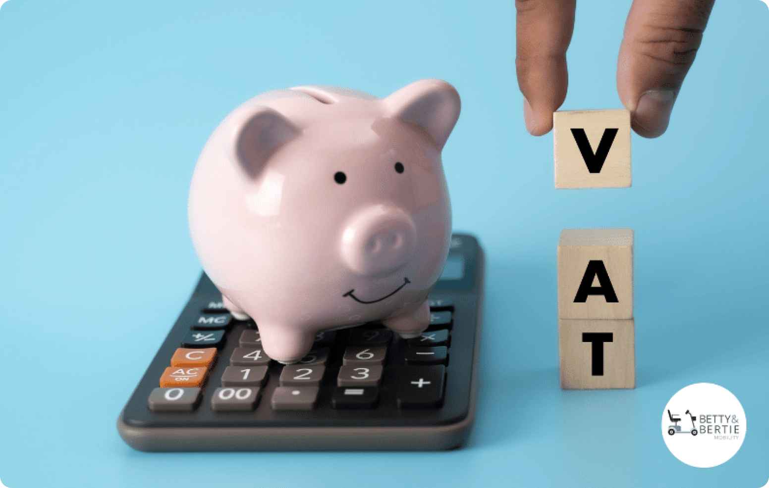 A pink ceramic pig shaped money box is sat on top of a calculator. Next to it as three wooden boxes with the letters VAT spelt out.