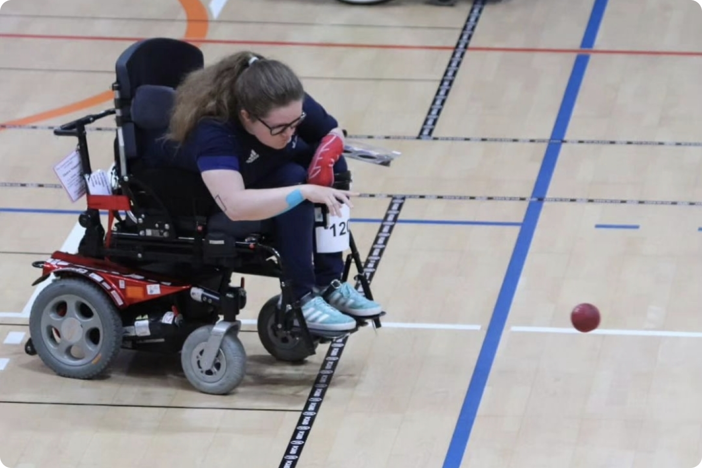 Photo of Claire Taggart playing boccia. She is sat in her wheelchair.