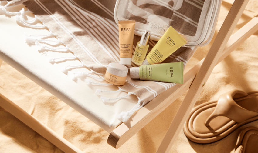 A range of ESPA skincare on a beach in neutral and beige colours