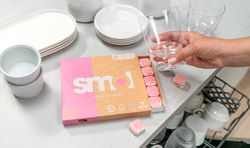 A range of Smol products on top of a dishwasher with clean glasses and plates