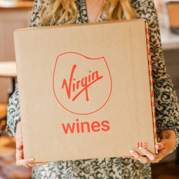 Virgin Wines delivery box held by a customer, perfect for gifting or restocking your favourites. Exclusive wine discounts for disabled shoppers. Shopping discounts for disabled people.