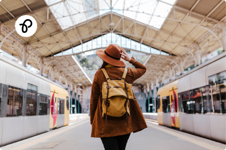 Disabled persons railcard a woman with a hat stands on a train station in between two trains saving money for disabled people