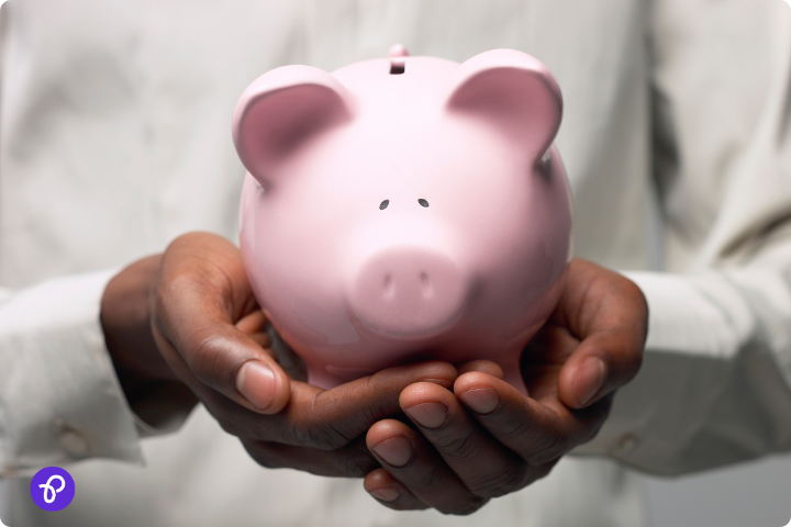 Man holding a pink piggy bank, symbolising saving money with effective budgeting.