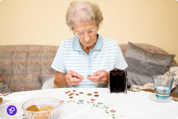 Elderly woman counting coins at a table, reflecting pension-saving tips for disabled individuals.