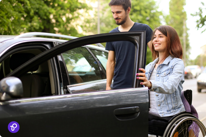 A woman in a wheelchair being assisted into a car, representing mobility and transportation savings.