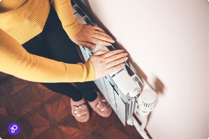 Hands warming on a radiator, symbolising support for disabled people managing energy bills in the UK