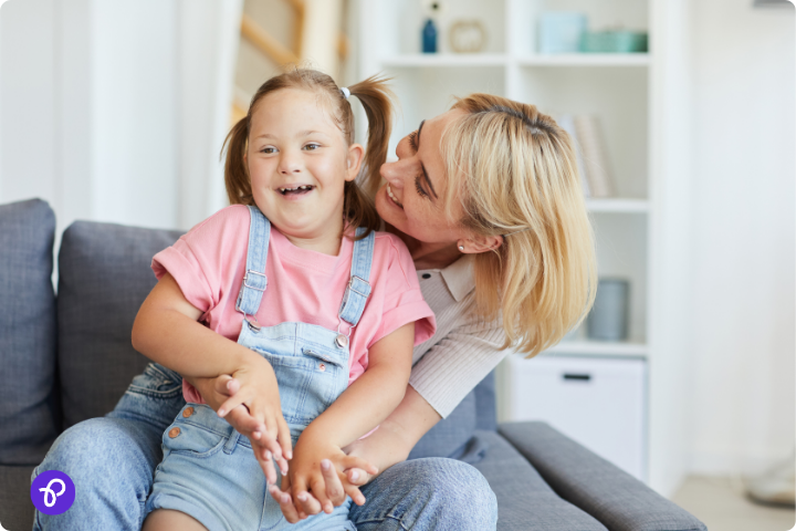 Smiling mother and child sharing a joyful moment, highlighting disability support services for families.