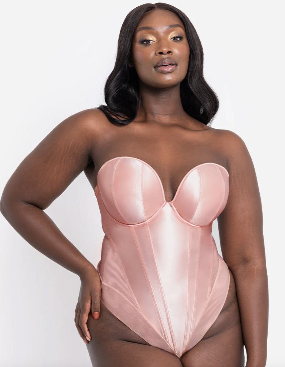 a pink rose body suit lingerie on a black lady who has black shoulder length hair