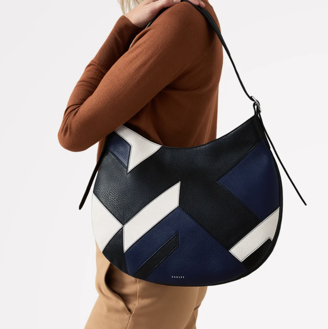 the Kensington place patchwork handbag on a models arm with a Radley discount code for disabled people