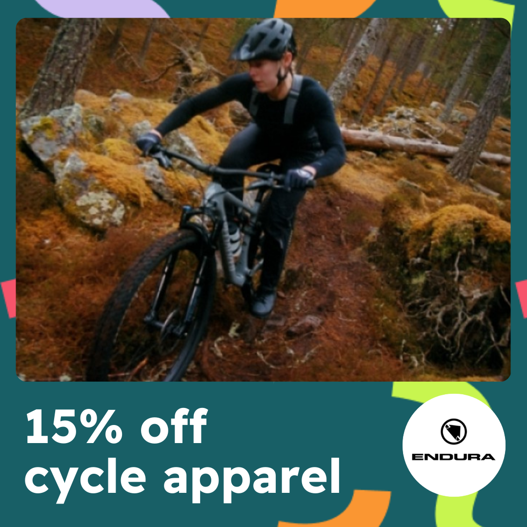 A green and multi coloured confetti frame has an image of a person riding a bike in wooded countryside with text reading 15% off cycle apparel