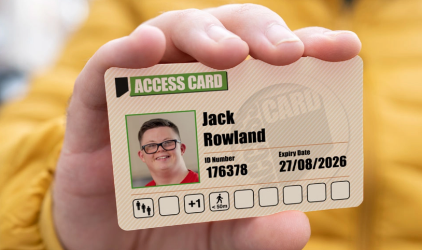 A white hand is holding an access card with the name Jack Rowland and a photo of a young white man