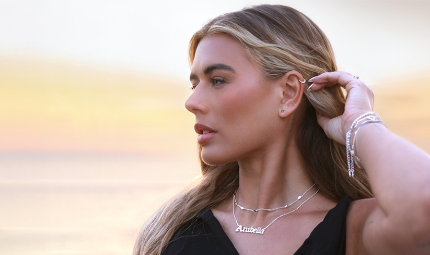 White woman with blonde hair poses wearing necklaces, earrings and bracelets from Say It With jewellery