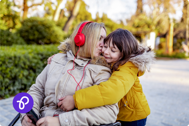 A mother is a wheelchair user and is hugging a small child in a park in a blog post about Mothers Day gift ideas and Purpl Disabled Discounts