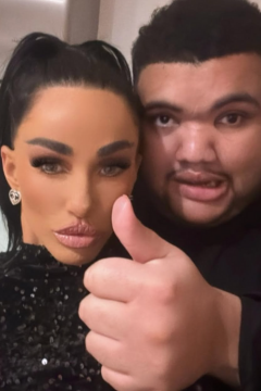 Katie Price posing for a selfie with her son Harvey, who is giving a thumbs up, both smiling slightly with their heads close together, dressed in black outfits.
