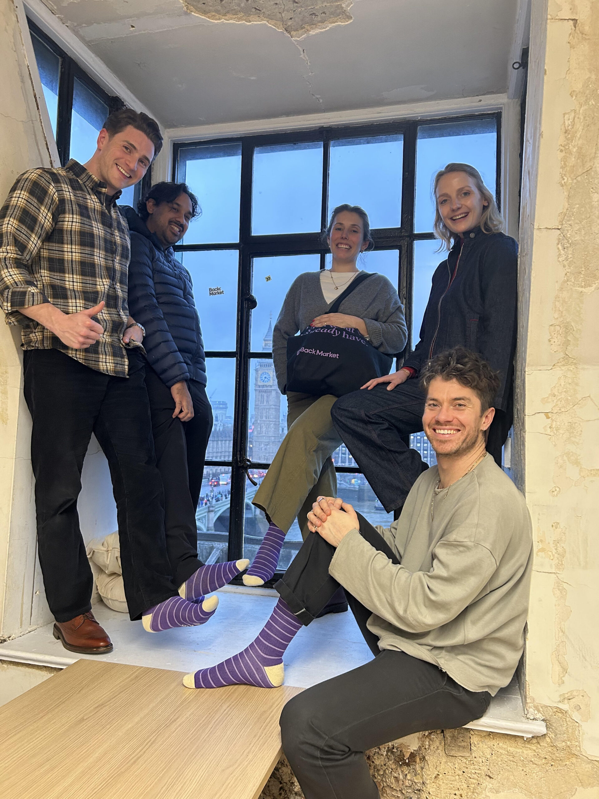 Group of Backmarket team members wearing purple socks to support Purple Sock Day, showing solidarity with people living with disabilities and long term health conditions, promoting inclusion and awareness.